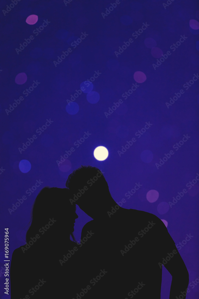 Silhouettes of a young couple under the de-focused starry sky. My astronomy work.