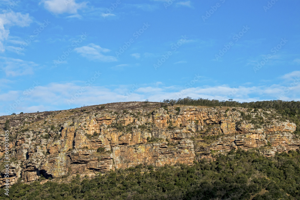  Green Trees Rocky Cliff Against Blue Cloudy Sky Landscape