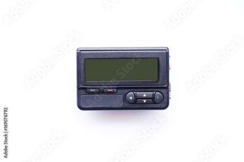 Old beeper or pager isolated on white background photo