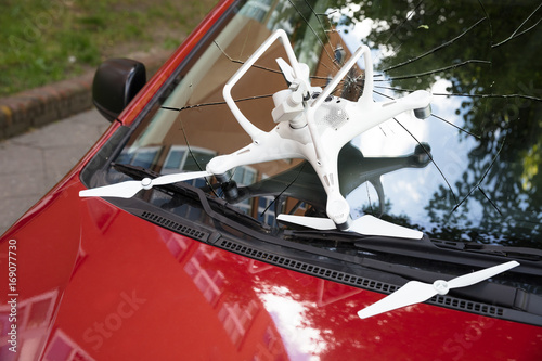 Fotografie Damaged white drone on broken car windshield