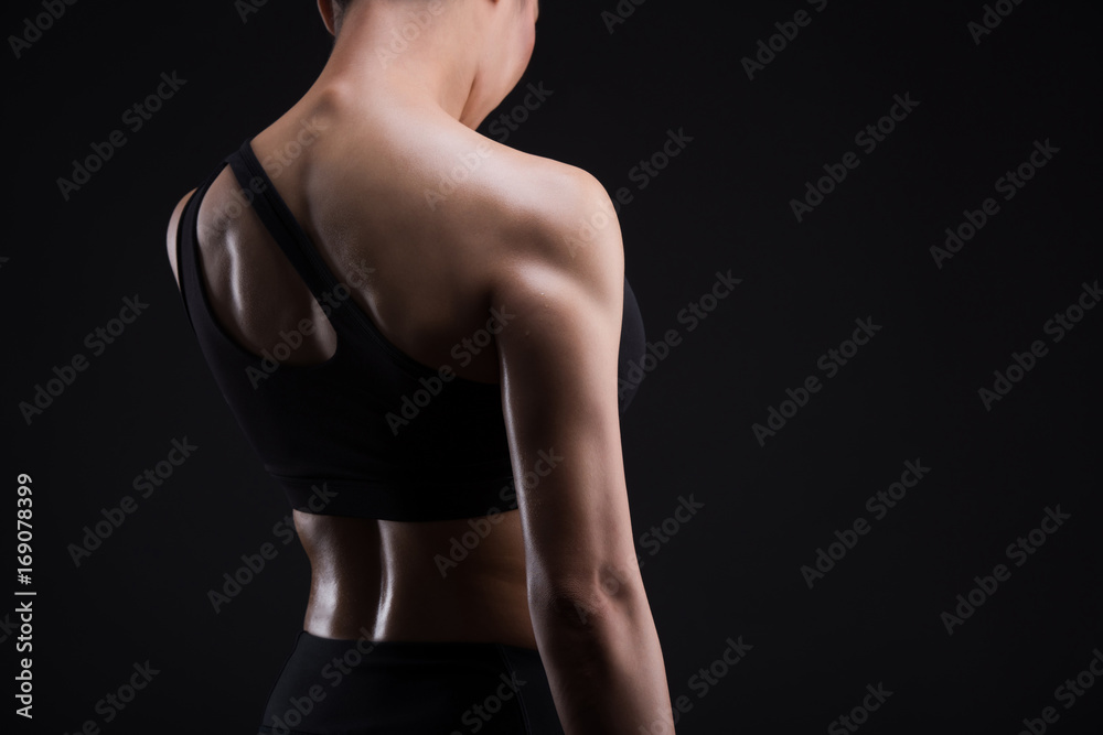 Fototapeta premium Asian sporty woman with Arms Pain,on a black background,sport,fitness, bodybuilding,healthy and lifestyle concept.