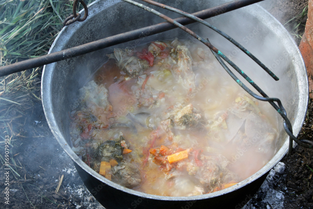 Cooking goulash in a kettle on the open fire Cooking goulash in a kettle on the open fire