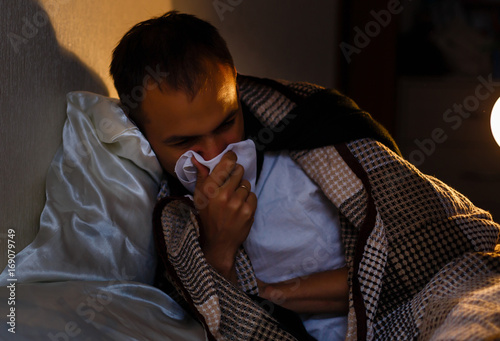 Vászonkép wrapped in the warm knitted blanket, sick, bearded man with a red nose snotty dr
