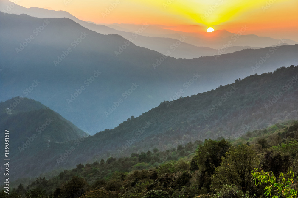 Obraz premium Sunrise over mountains layer range
