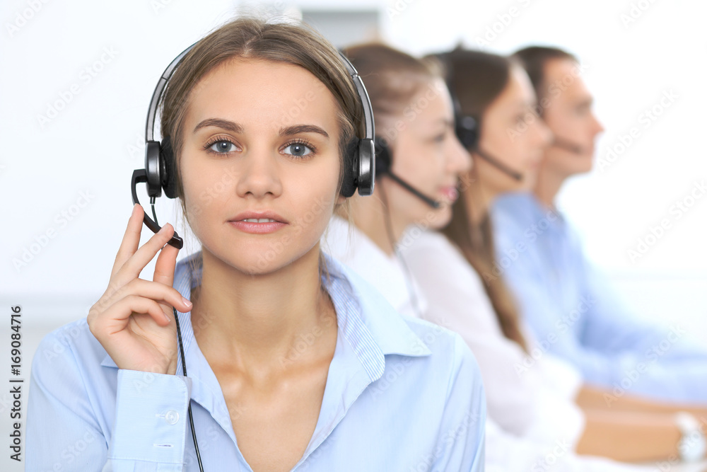 Call center operator in headset while consulting client. Telemarketing or phone sales. Customer service and business concept Call center operator in headset while consulting client. Telemarketing or phone sales. Customer service and business concept