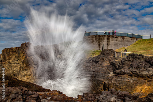 Tourists watch as the famous Kiama Blowhole erupts. The world's largest, it attracts close to 1m visitors every year. photo