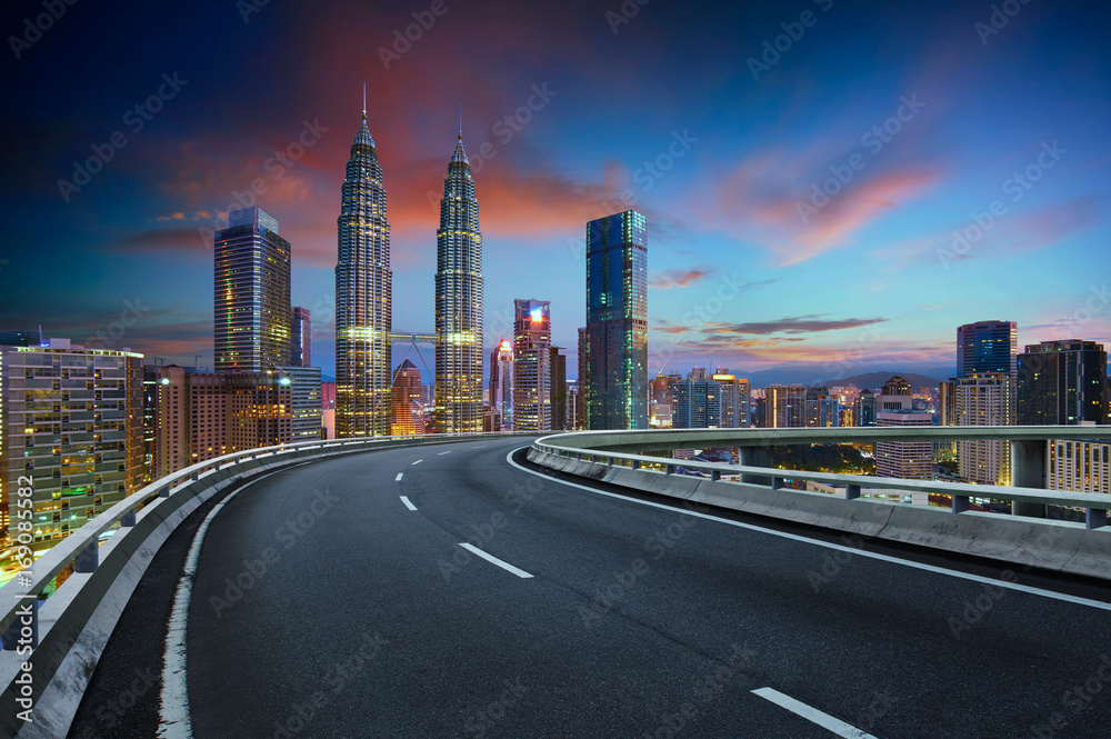 Flyover with beautiful Kuala Lumpur city skyline , Twilight scene .