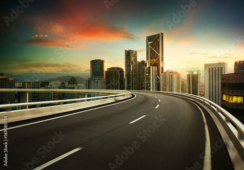 Highway overpass motion blur with city background .