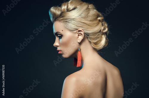 beautiful young woman in studio on a dark background. Fashion portrait