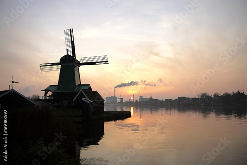 The windemill in the Kinderdijk town in Holland, with the landscape of village, river, meadow and farm © shenmanjun