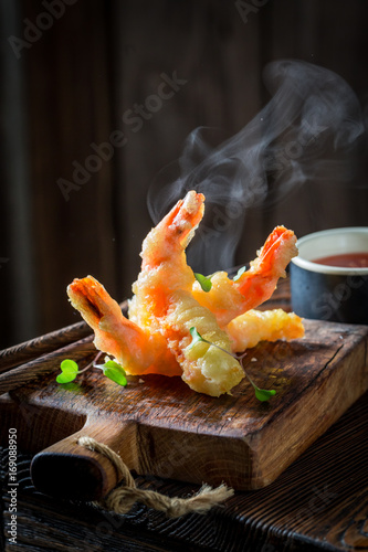 Closeup of shrimp in tempura with sour sauce and sweet
