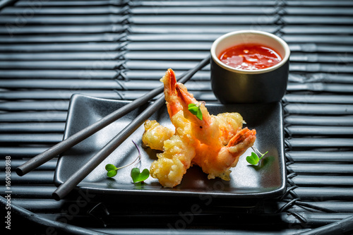 Closeup of shrimp in tempura with sweet and sour sauce