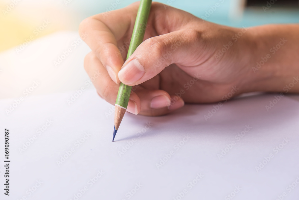 pencil in hand Woman on white paper . pencil in hand Woman on white paper .
