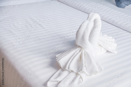 swan of white towel on bed