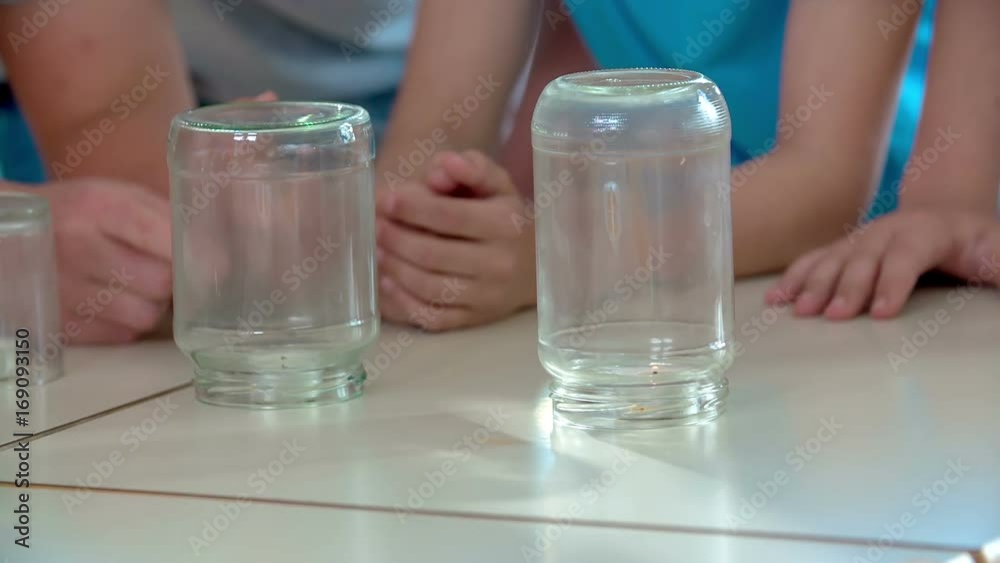 Almost all three candles have burnt. They were standing under cups and glasses and kids were doing a chemical experiment. Almost all three candles have burnt. They were standing under cups and glasses and kids were doing a chemical experiment.