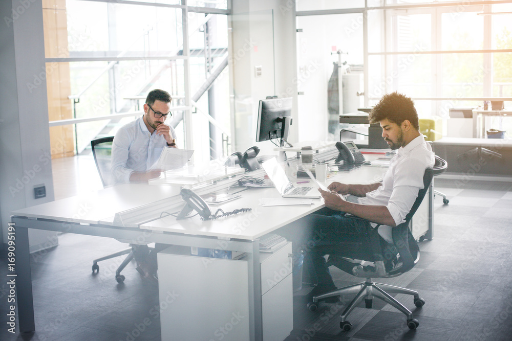 Two business men working in office. Colleague in office together. Two business men working in office. Colleague in office together.