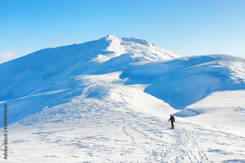 A man hiking in winter mountains