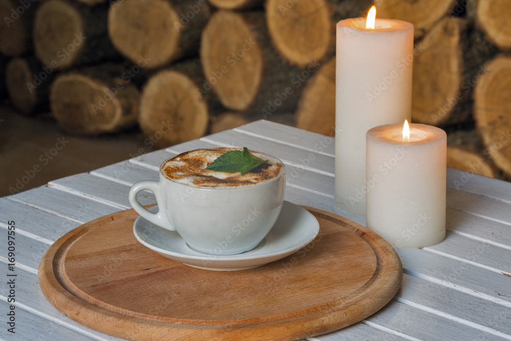 Coffee cup on bar table and romantic candles closeup Coffee cup on bar table and romantic candles closeup