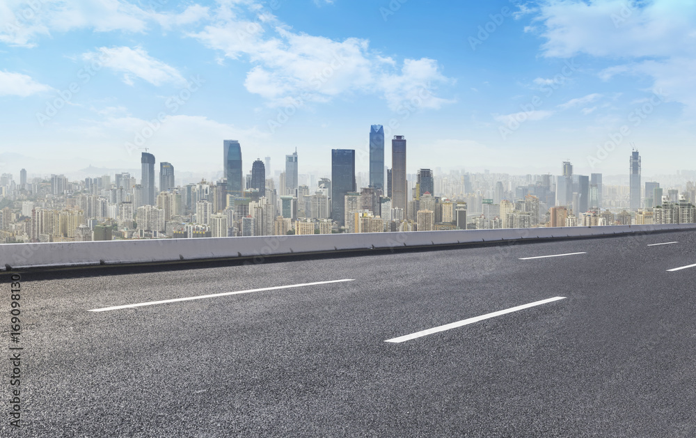 Road pavement and city skyline Road pavement and city skyline
