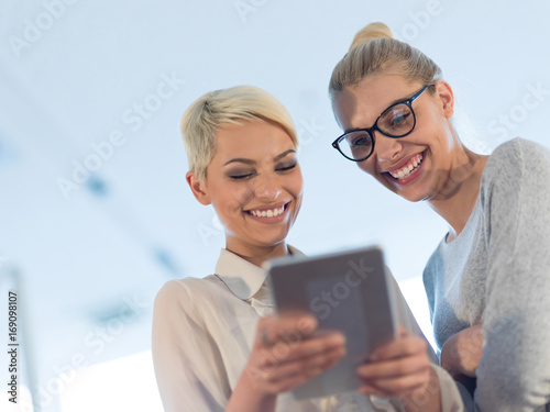 Pretty Businesswomen Using Tablet In Office Building during conference