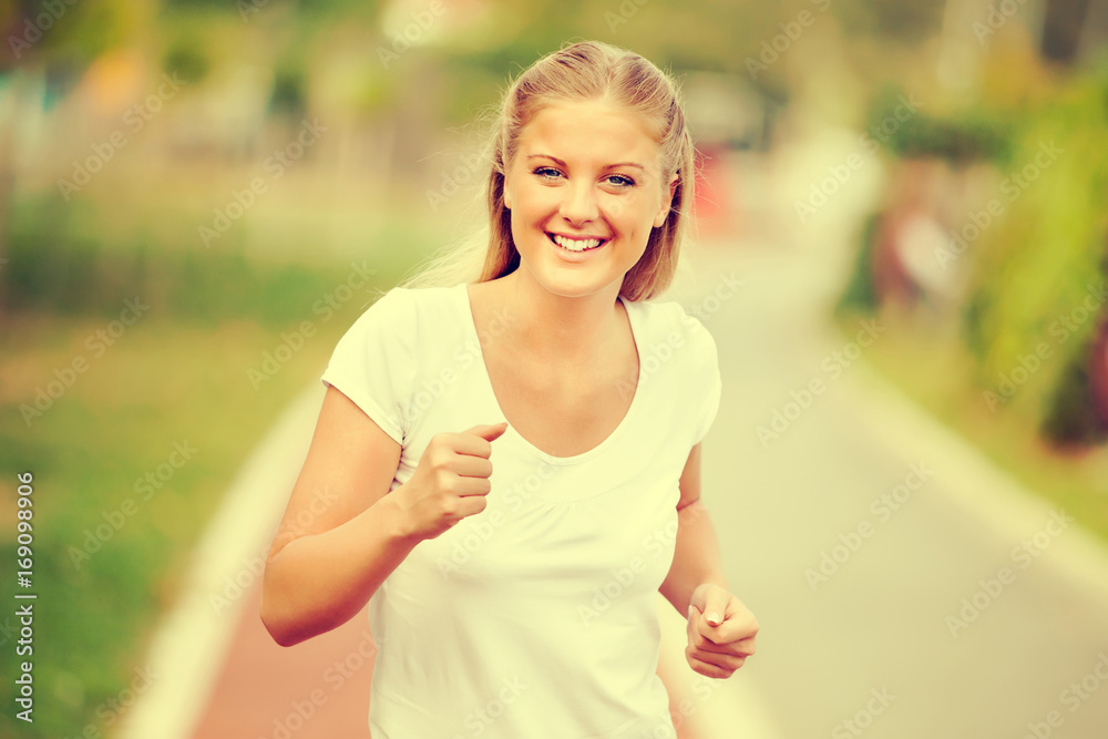 Young woman is jogging on sunny day. Young woman is jogging on sunny day.