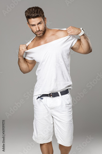 Sexy male model streaching his tshirt