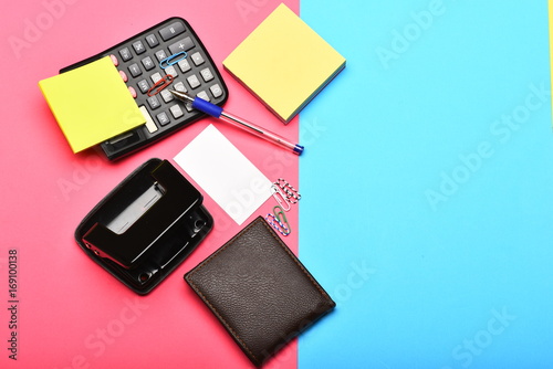 Calculator, hole punch, business card, note paper, pen and clips