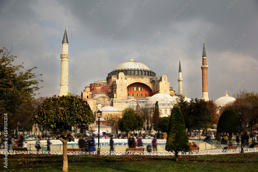 View of Hagia Sophia Aya Sofia, Christian patriarchal basilica, imperial mosque and now a museum, Istanbul, Turkey on a cloudy autumn day, people with motion blur