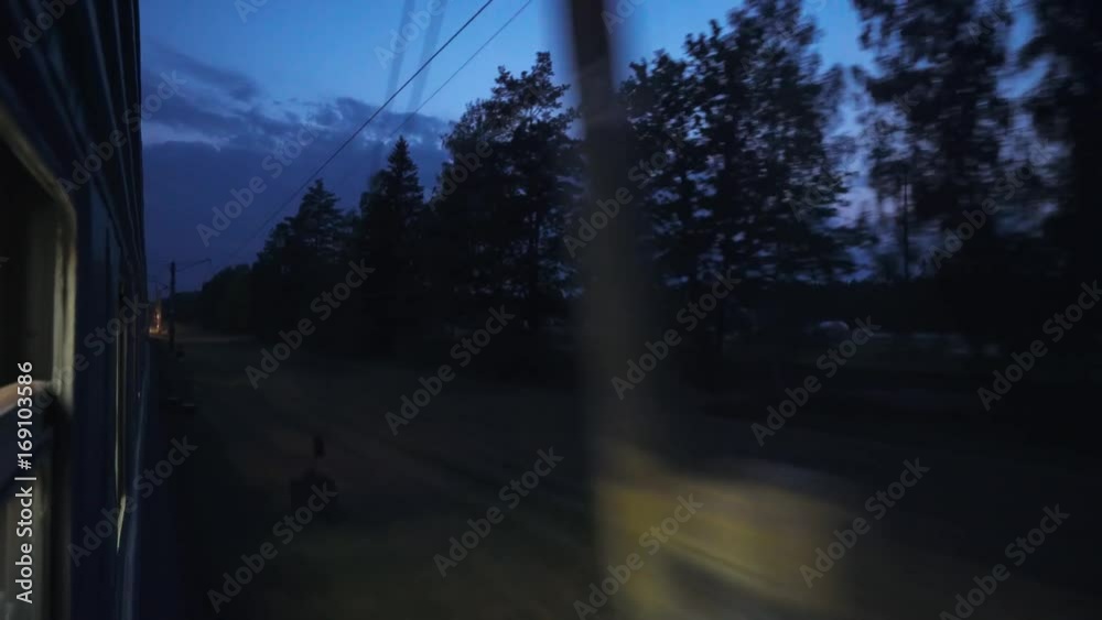 Night, the train is traveling by rail, view from the train window, the blue sky.
