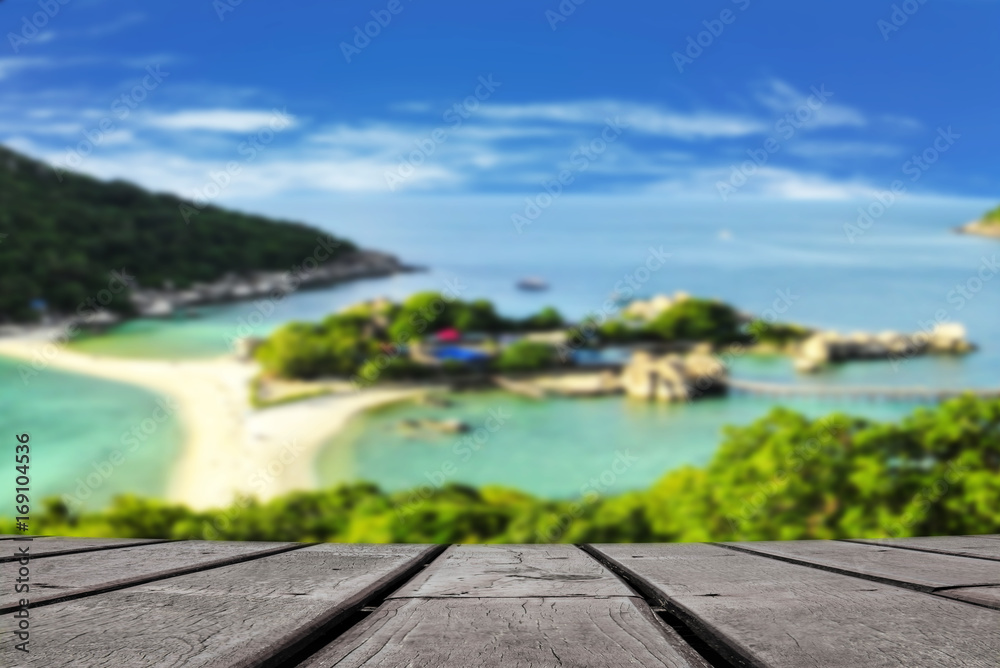 Wooden background with blurred seascape look from the top of hill