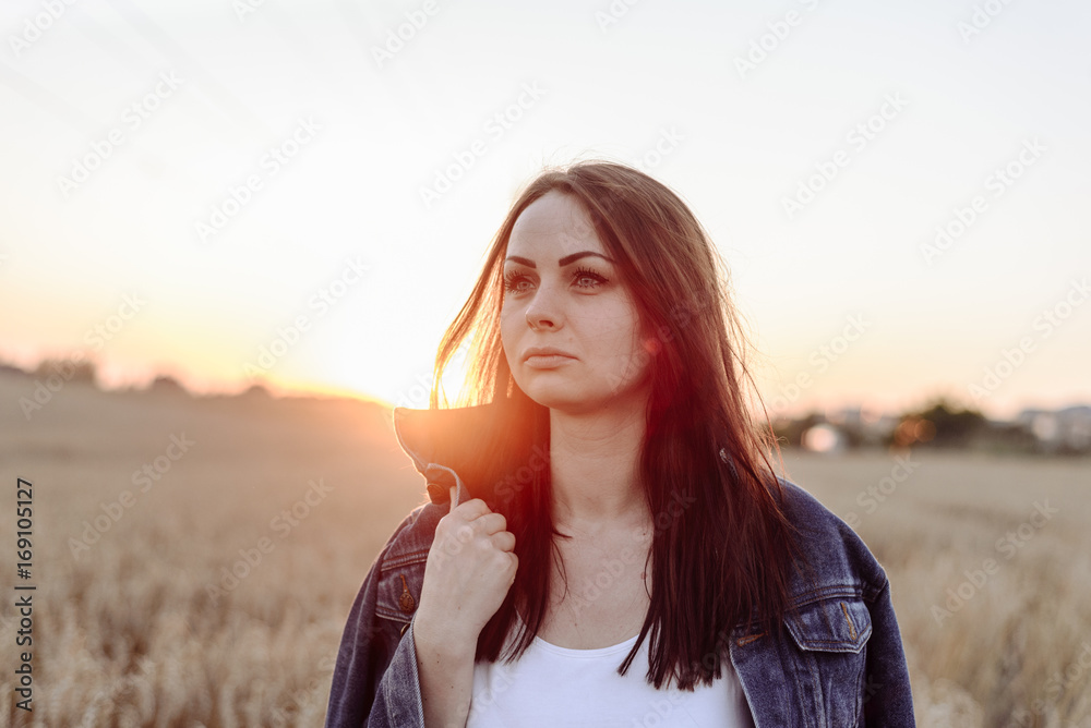 Portrait of happy young beautiful woman brunette in field wheat sunset evening Portrait of happy young beautiful woman brunette in field wheat sunset evening