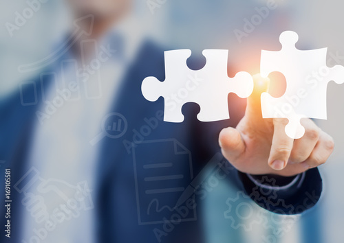 Mergers and acquisition concept with consultant touching puzzle pieces icons photo