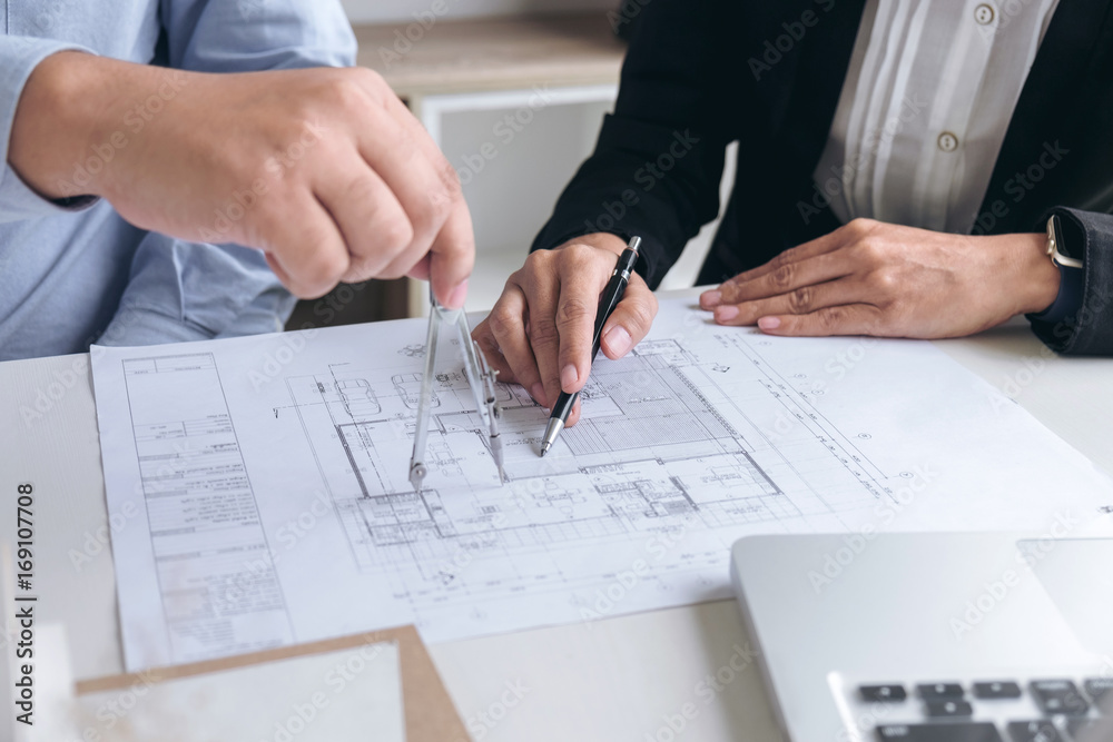 Engineering or Creative architect in construction project, Engineers hands working with compasses on construction blueprint building at a workplace in office, Building and architecture concept Engineering or Creative architect in construction project, Engineers hands working with compasses on construction blueprint building at a workplace in office, Building and architecture concept