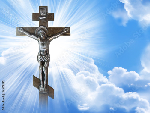Silhouette of the crucified Jesus Christ on the cross against the blue sky. The Biblical prophet is a symbol of death. Calvary, Christmas, Easter background.