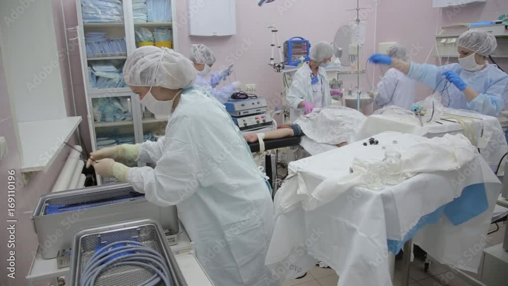 The surgeon's assistant pushes the endoscopic equipment into the container after the operation is completed