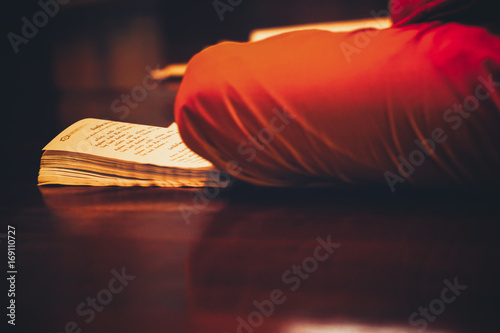 Monk praying in the temple with book thailand