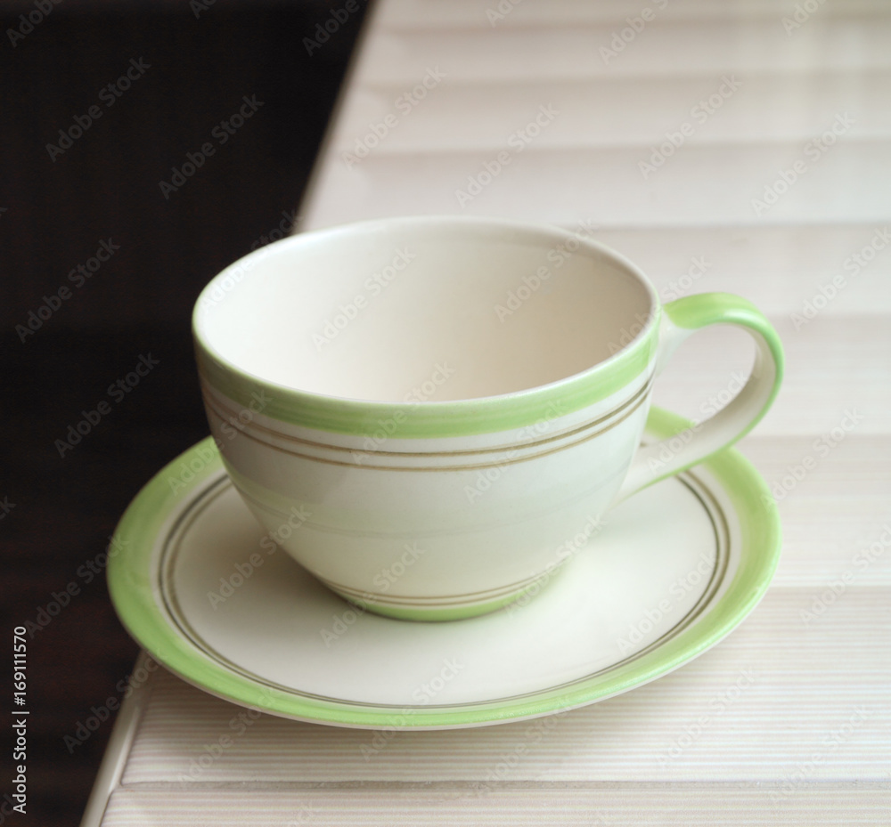 Blank cup with on the table in a cafe. Cup with tea or coffee Blank cup with on the table in a cafe. Cup with tea or coffee