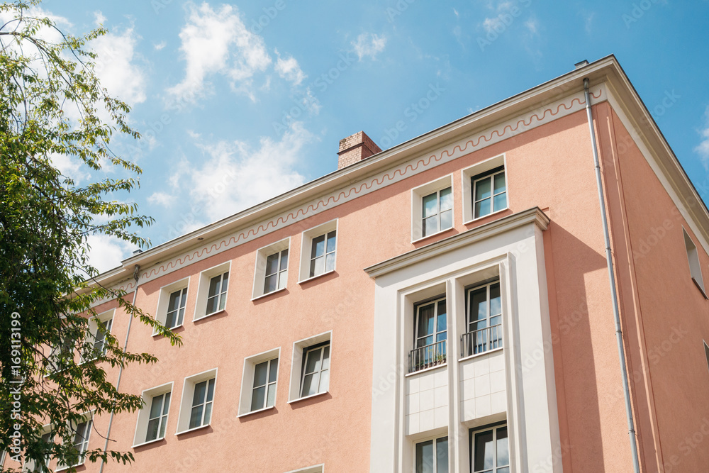 detailed view of apartment house with rose colored facade