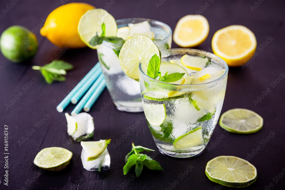 Refreshing drink with crushed ice and lime with lemon on dark background Refreshing drink with crushed ice and lime with lemon on dark background