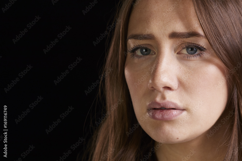 Close Up Head And Shoulders Studio Portrait Of Anxious Woman Close Up Head And Shoulders Studio Portrait Of Anxious Woman