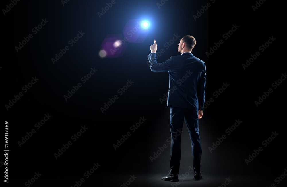 businessman in suit pointing finger to lens flare businessman in suit pointing finger to lens flare