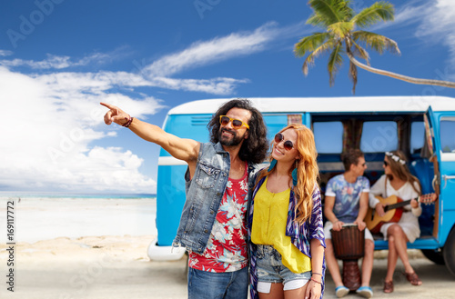 happy hippie couples and minivan on beach © Syda Productions