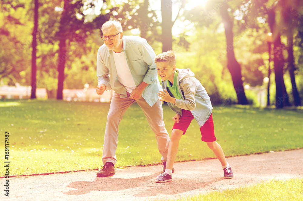 Fototapeta premium grandfather and grandson racing at summer park