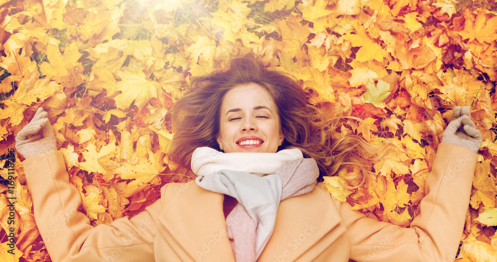 beautiful happy woman lying on autumn leaves beautiful happy woman lying on autumn leaves