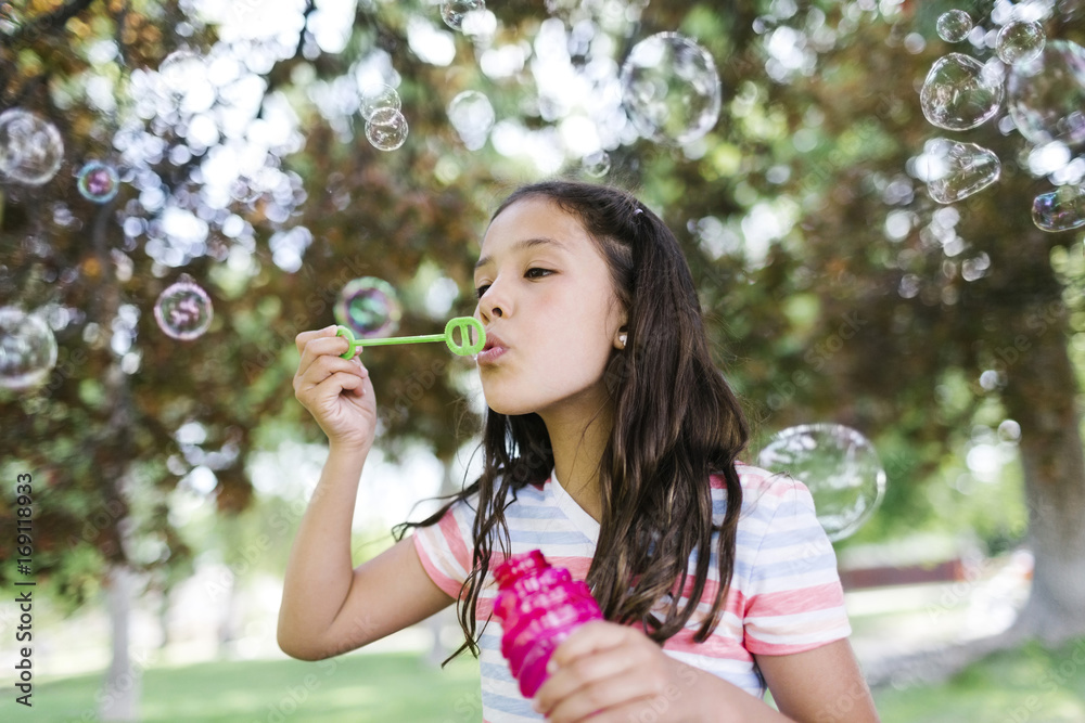 Portrait of girl ( 10-11 ) blowing soap bubbles Portrait of girl ( 10-11 ) blowing soap bubbles