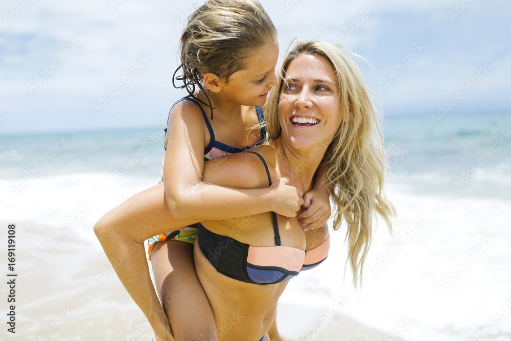 Mother carrying daughter (6-7) on back Mother carrying daughter (6-7) on back