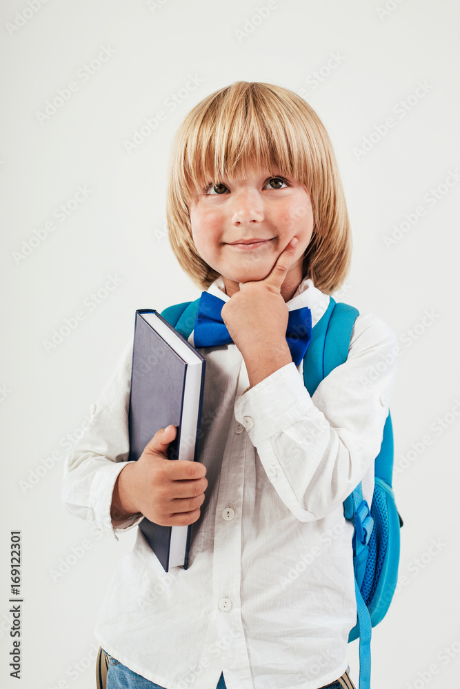Portrait of happy schoolboy with books and apple isolated on white background. Education, isolated. School preschool Portrait of happy schoolboy with books and apple isolated on white background. Education, isolated. School preschool