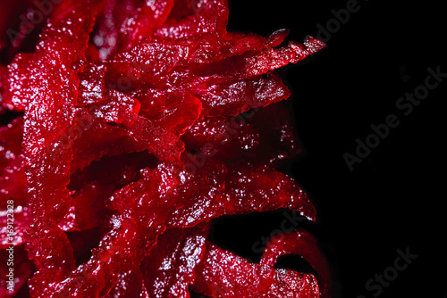 Macro background of grated beetroot isolated on a black background