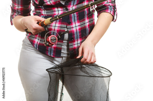 Woman hand holding fishing rod and keepnet photo