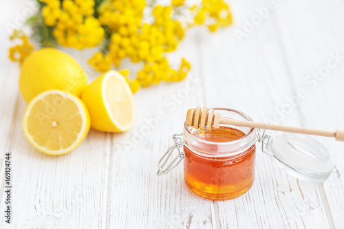 Useful and delicious honey and lemon. Honey dipper. Copy space. The concept of healthy food, vegetarianism, autumn, colds,  treatment, cure, therapy, medication.